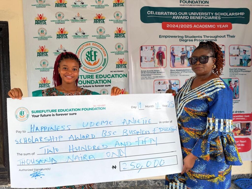 Students receiving scholarship cheque at Surefuture Education Foundation Award Ceremony in Uyo